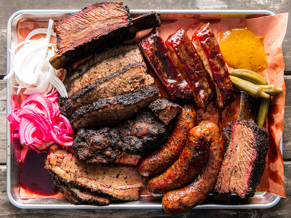 Barbecue platter featuring smoked brisket, beef ribs and sausages from Horn Barbecue